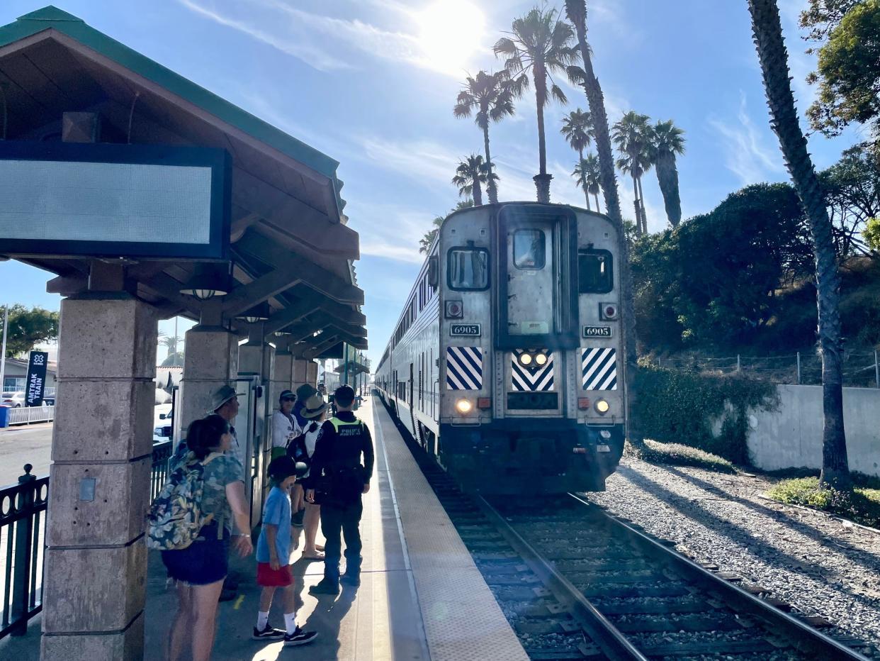 Families wait as an Amtrak Surfliner pulls into downtown Ventura's train station Friday.