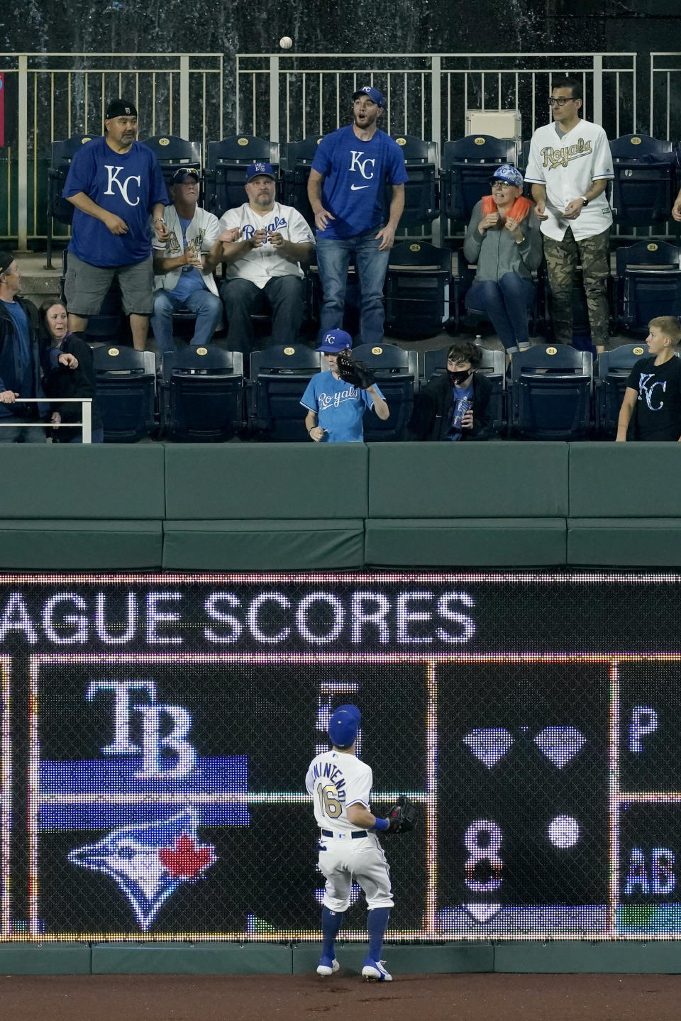 Kansas City Royals left fielder Andrew Benintendi watches a grand slam by Detroit Tigers' Miguel Cabrera during the seventh inning of a baseball game Friday, May 21, 2021, in Kansas City, Mo. (AP Photo/Charlie Riedel)