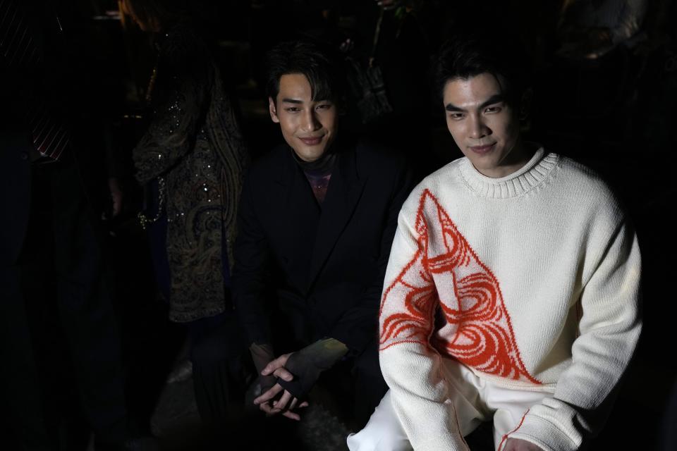 Thai actor and singer Phakphum Romsaithong, also known as Mile, right, and Thai actor and model Nattawin Wattanagitiphat, also known as Apo, wait for the Dior pre-fall 2023 collection show in Mumbai, India, Thursday, March 30, 2023. (AP Photo/Rafiq Maqbool)