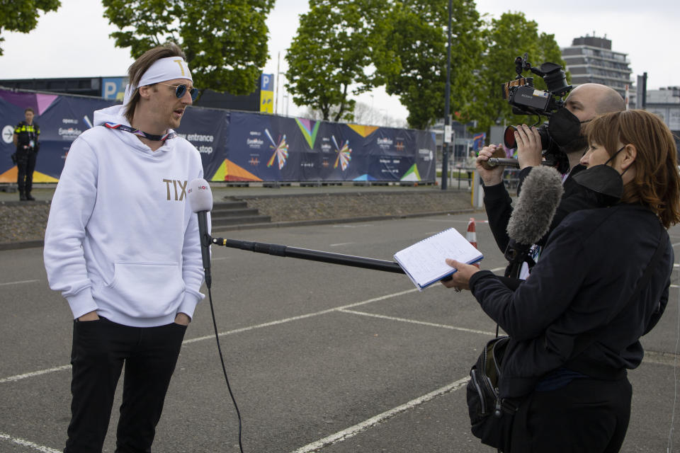 In this photo taken on May 15, 2021 Norway's Andreas Haukeland, known as TIX, is interviewed by Dutch national broadcaster NOS as he arrives for rehearsals at the Eurovision Song Contest at Ahoy arena in Rotterdam, Netherlands, Saturday, May 15, 2021. After last year's Eurovision Song Contest was canceled amid the global COVID-19 pandemic, it is roaring back to life with coronavirus bubbles added to its heady mix of music and camp. (AP Photo/Peter Dejong)