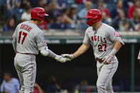 Los Angeles Angels' Mike Trout, right, is congratulated by Shohei Ohtani after hitting a two-run home run off Cleveland Guardians starting pitcher Konnor Pilkington during the fifth inning of a baseball game, Monday, Sept. 12, 2022, in Cleveland. (AP Photo/David Dermer)