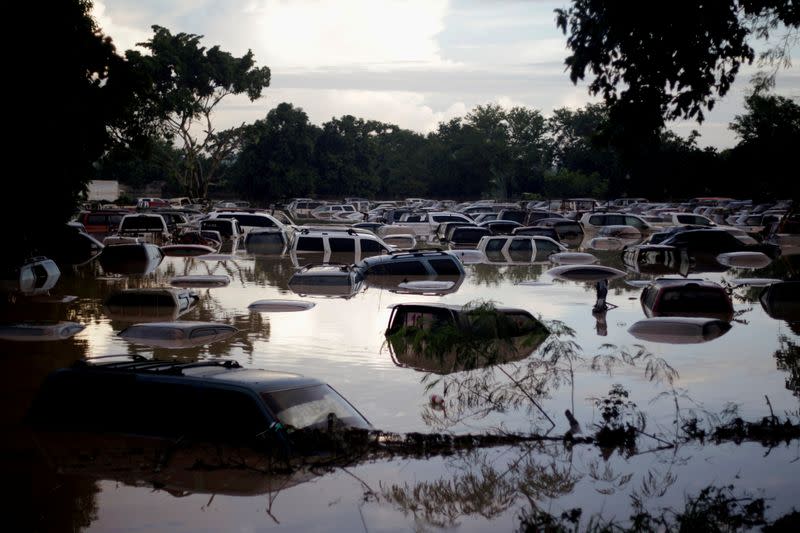 FILE PHOTO: Vehicles are submerged at a plot flooded by the Chamelecon River due to heavy rain caused by Storm Iota, in La Lima
