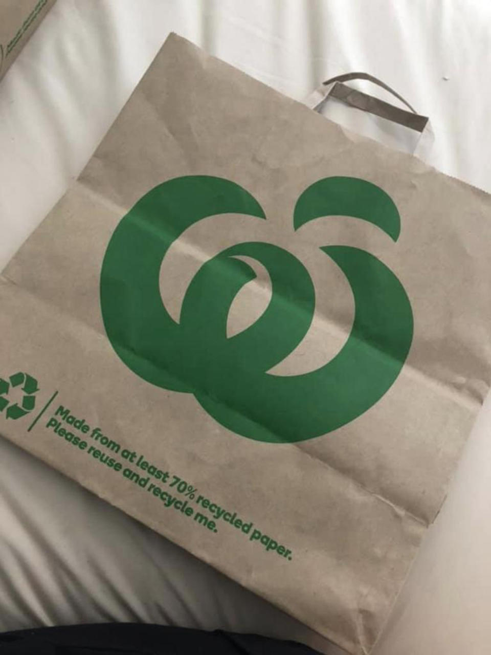 A Woolworths paper shopping bag with a large green Woolworths logo. Photo: Facebook.