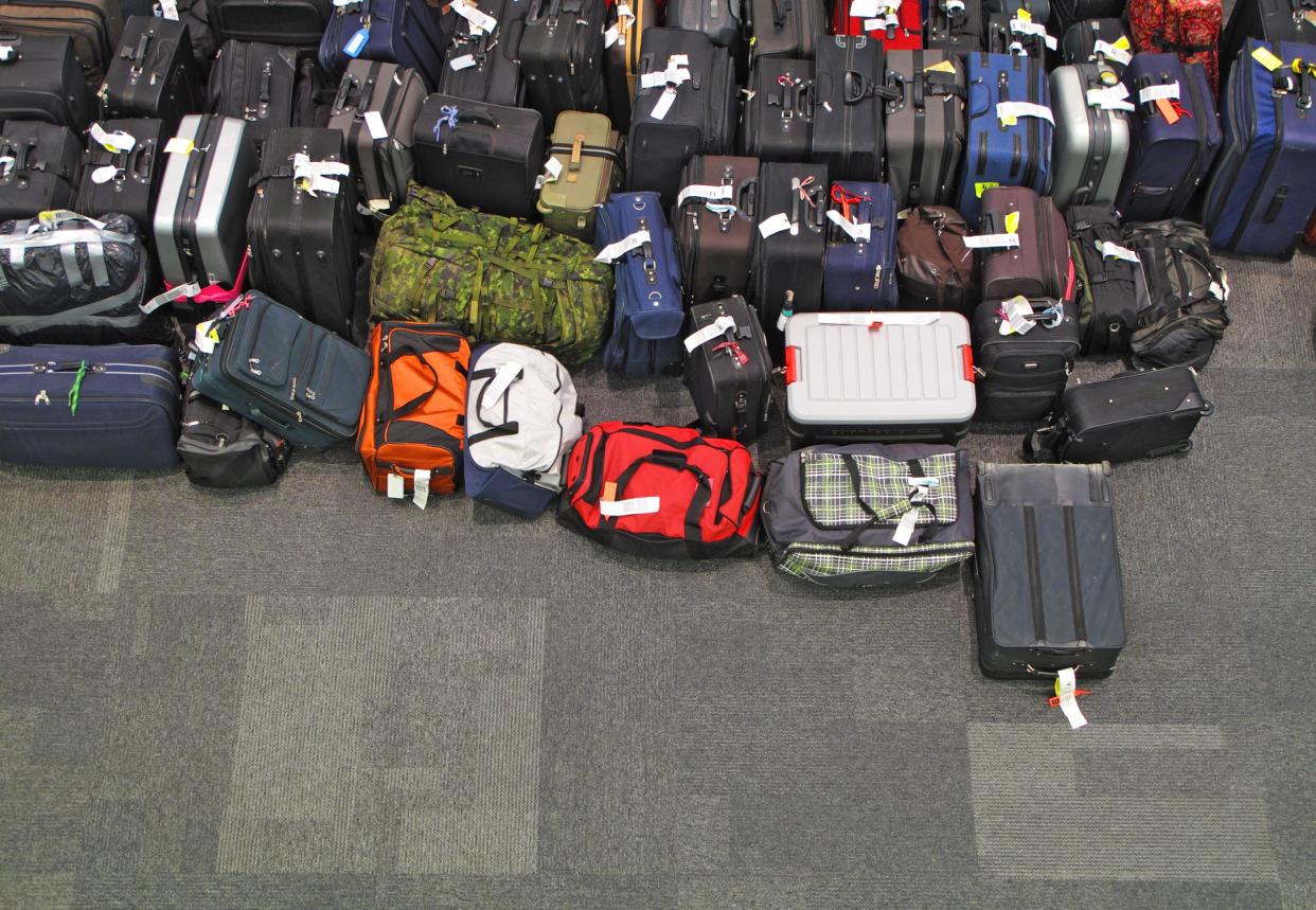 Dozens of suitcases in the airport floor