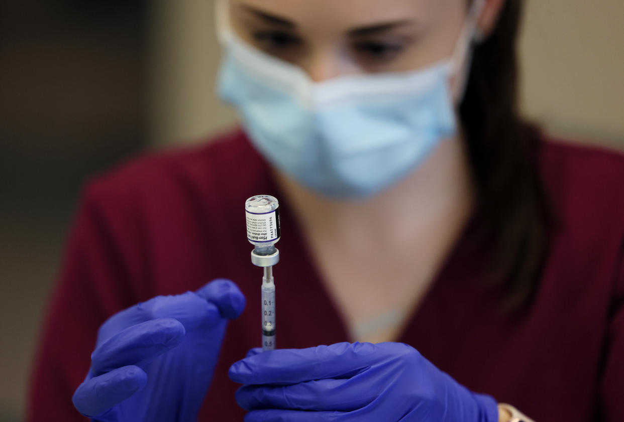 A nurse draws a dose of the Pfizer COVID-19 vaccine.