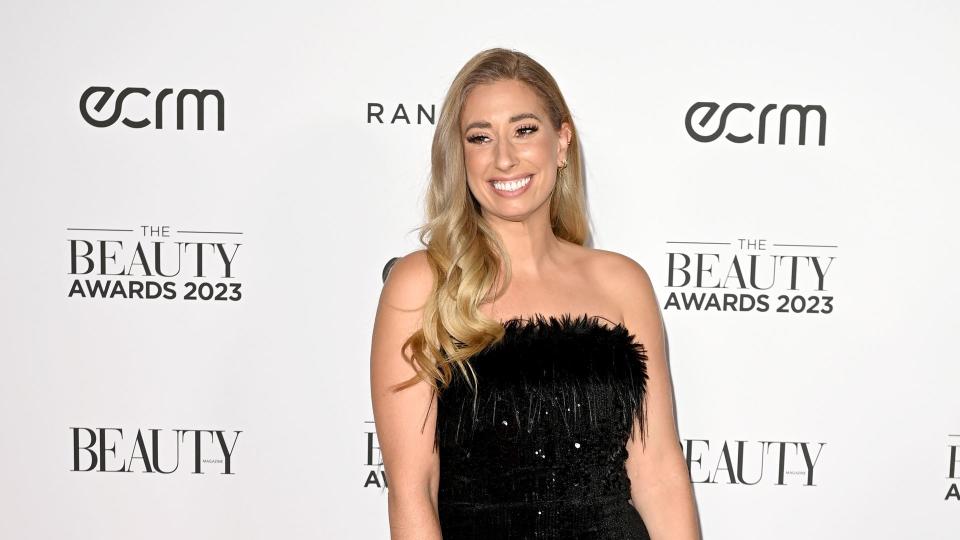 stacey in black dress on red carpet 