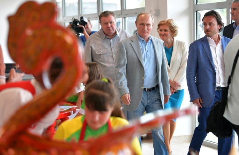 Russian President Vladimir Putin (C) visits a youth holiday facility outside Yalta, Crimea, which was denounced by Kiev as violating its sovereignty