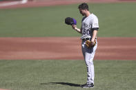 Colorado Rockies' Chi Chi González looks at his hat after allowing two runs in the first inning against the San Francisco Giants during the second inning of a baseball game in San Francisco, Thursday, Sept. 24, 2020. (AP Photo/Jed Jacobsohn)