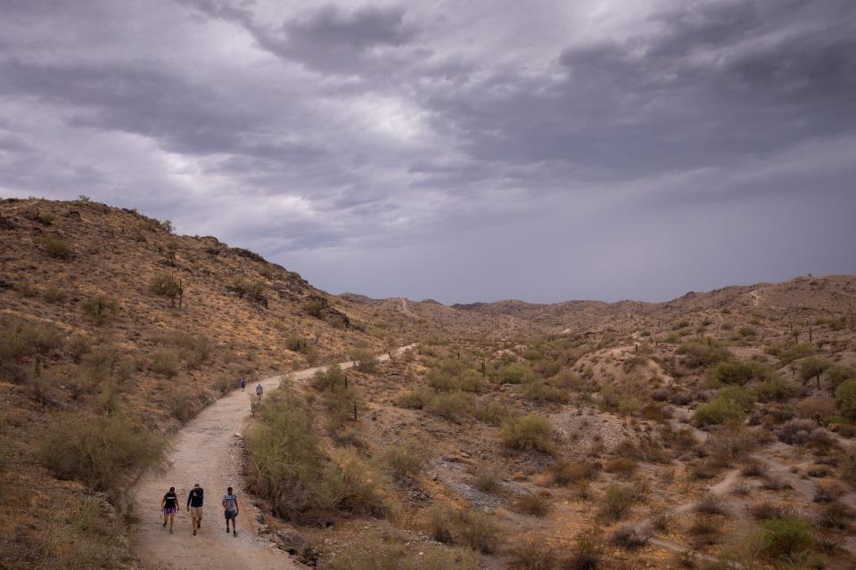 Even on an overcast day, hikers enjoy a walk in Pima Canyon in South Mountain Park/Preserve in Phoenix.