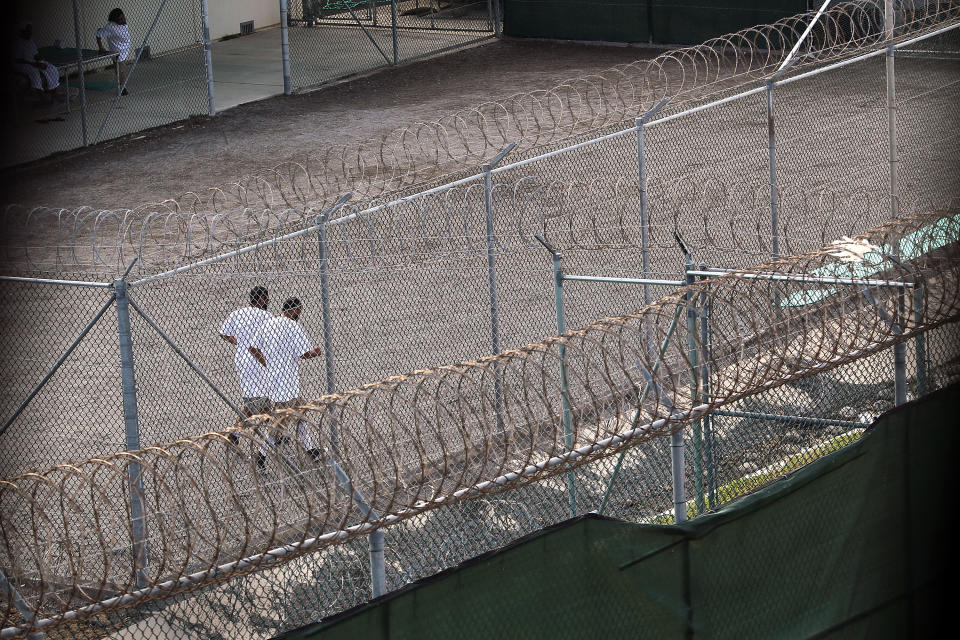 GUANTANAMO BAY, CUBA - MARCH 30:  (EDITORS NOTE: Image has been reviewed by the U.S. Military prior to transmission.) Detainees jog inside a recreation yard at Camp 6 in the Guantanamo Bay detention center on March 30, 2010 in Guantanamo Bay, Cuba. U.S. President Barack Obama pledged to close the prison by early 2010 but has struggled to transfer, try or release the remaining detainees from the facility, located on the U.S. Naval Base at Guantanamo Bay, Cuba.  (Photo by John Moore/Getty Images)