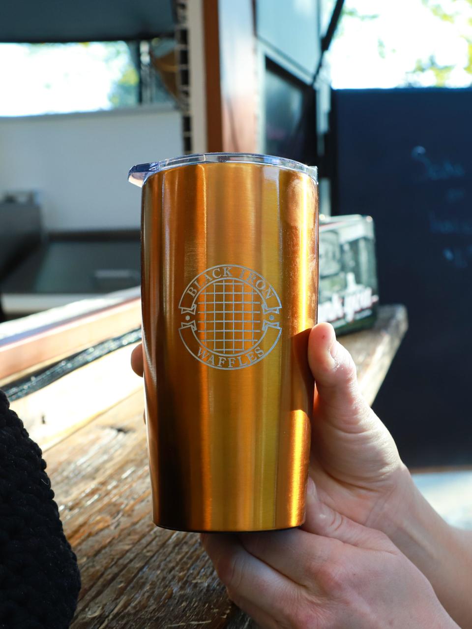 Black Iron Waffles has merchandise like this tumbler for sale. Chris Brockevelt, who is an architect by trade, designed the logo himself.