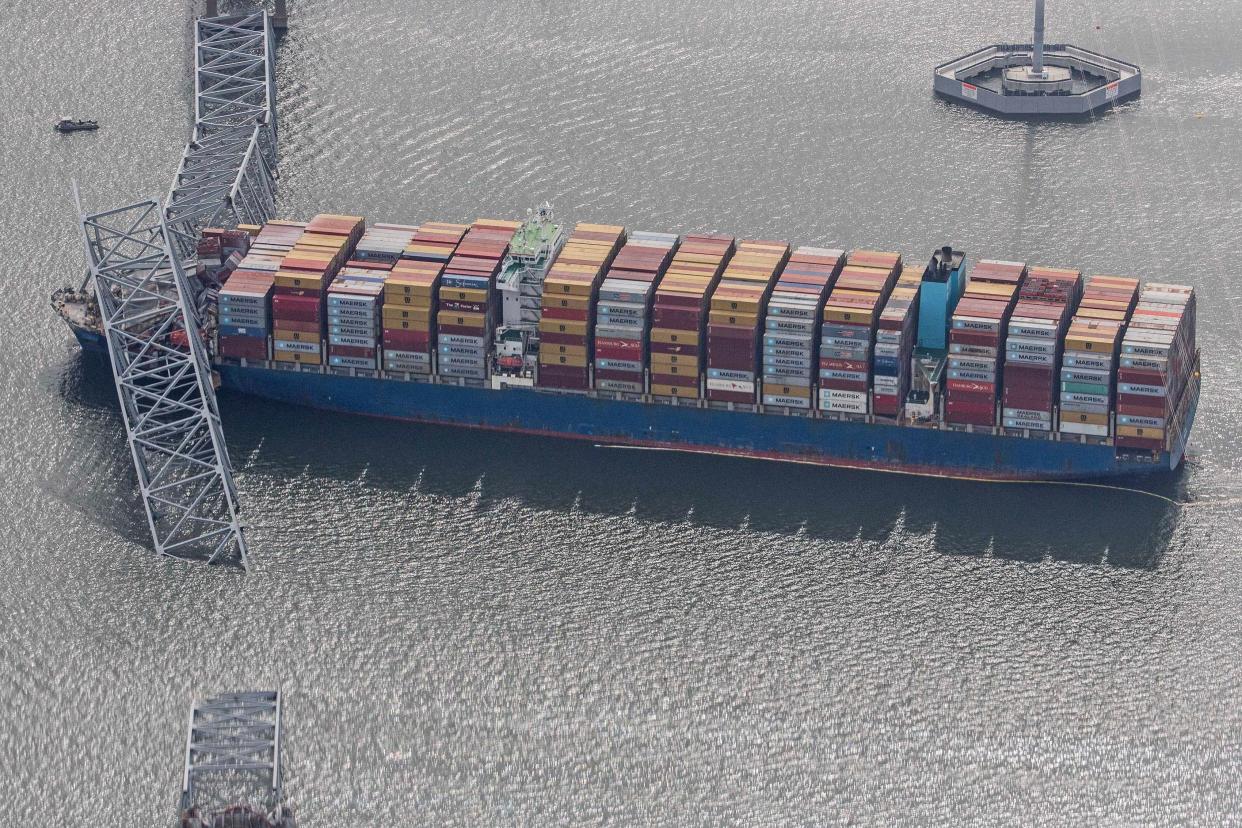 The container ship Dali is shown amidst the wreckage of the collapsed Francis Scott Key Bridge in Baltimore, Tuesday, March 26, 2024. Six people are missing after the Dali lost power and crashed into one of the bridge's support columns.