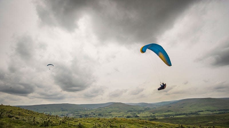 A photo of paragliders floating above fields in Yorkshire. 