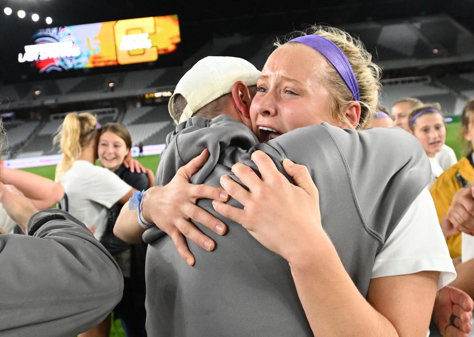 Copley midfielder Emma Niemczura, facing, hugs coach Wally Senk after winning the OHSAA Division II girls state soccer championship game at Lower.com Field, Friday, Nov. 11, 2022, in Columbus, Ohio.