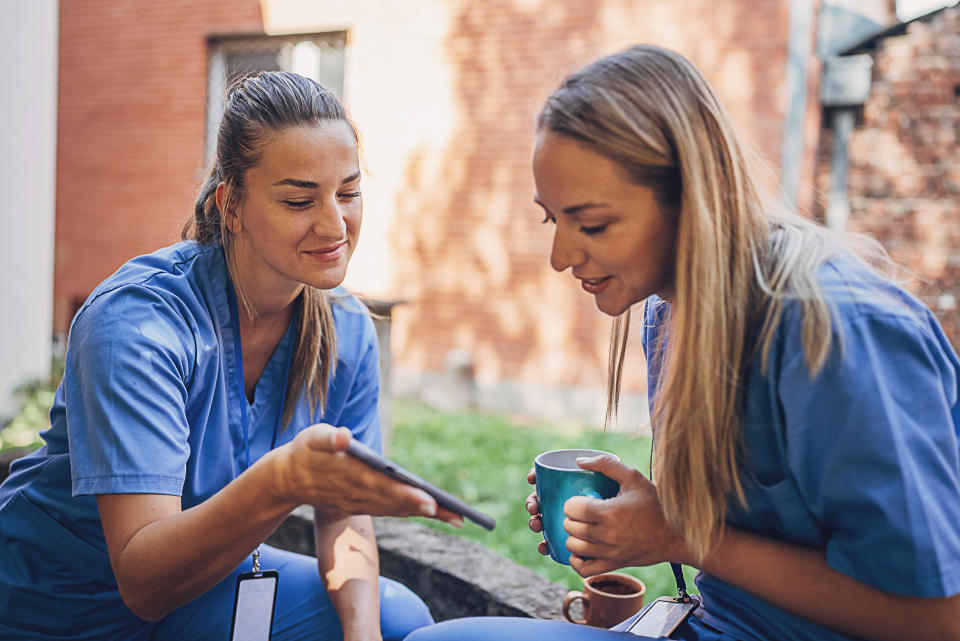 two young nurses gossiping on their break