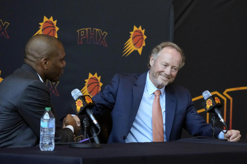 New Phoenix Suns head coach Mike Budenholzer, right, smiles as he shakes hands with James Jones, Suns president of basketball operations and general manager, during an NBA news conference introducing him Friday, May 17, 2024, in Phoenix. (AP Photo/Ross D. Franklin)