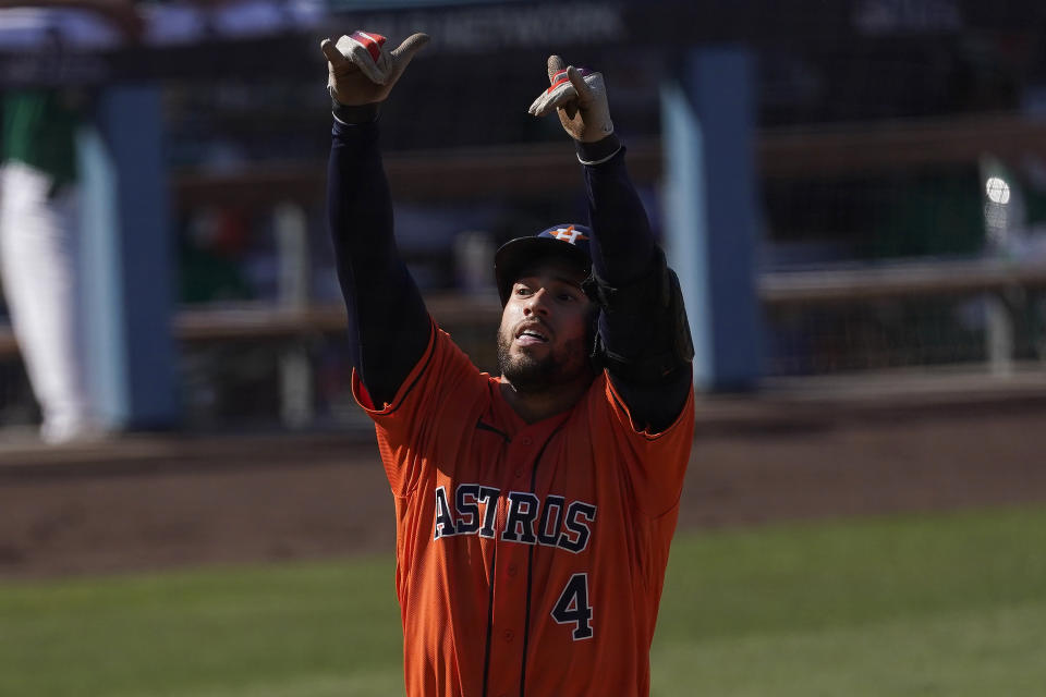 Houston Astros' George Springer celebrates after hitting a solo home run off of Oakland Athletics relief pitcher Yusmeiro Petit during the fifth inning of Game 2 of a baseball American League Division Series in Los Angeles, Tuesday, Oct. 6, 2020. (AP Photo/Ashley Landis)