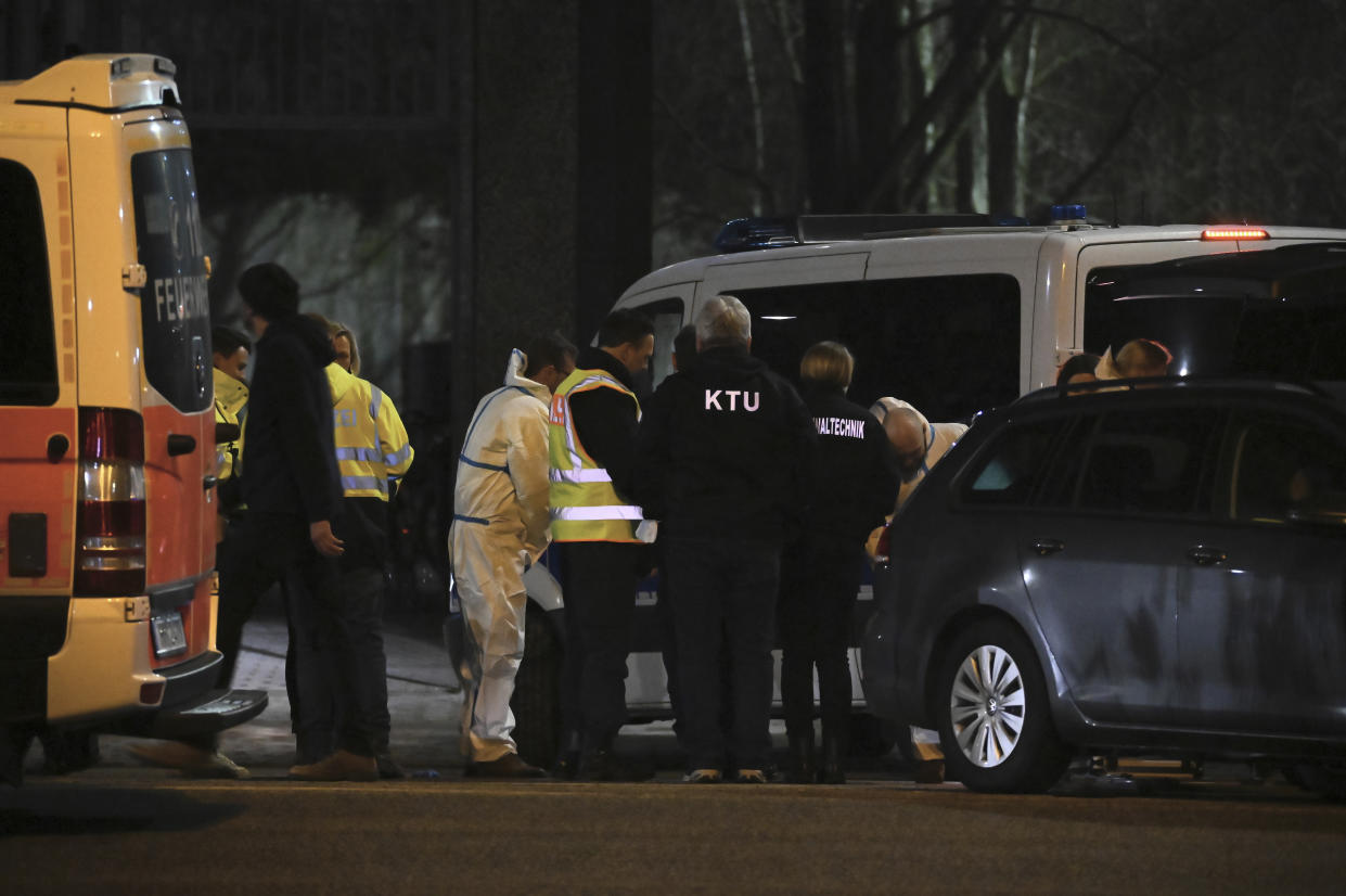 Employees of the Hamburg police forensics department stand next to a building used by Jehovah's Witnesses in Hamburg, Germany, Thursday, March 9, 2023. German police say shots were fired inside the building and an unspecified number of people were killed or wounded. The shooting took place Thursday evening in the Gross Borstel district. (Jonas Walzberg/dpa via AP)