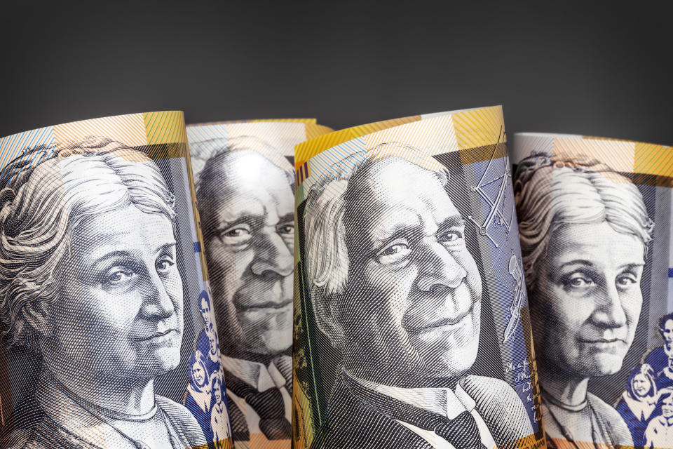 Australian money background.  Fifty dollar notes against dark background.