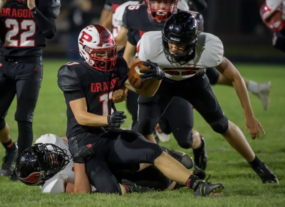 Metamora defenders bring down Pekin's Blake Youngren in the second half Friday, Sept. 30, 2022 in Pekin. The Dragons rolled over the Redbirds 55-13.