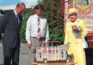 <p>The Queen and Prince Philip view a model of a traditionally painted truck in the compound of the British High Commission in Pakistan. The Queen arrived on her second state visit to Pakistan as the country celebrated its 50th anniversary of independence from British colonial rule. (Photo by TANVEER MUGHAL/AFP via Getty Images)</p> 