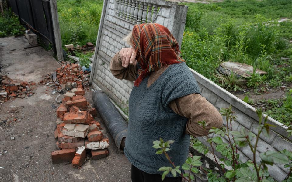 An elderly woman cries in front of her burnt house in Novoselivka, Ukraine - Alexey Furman/Getty Images