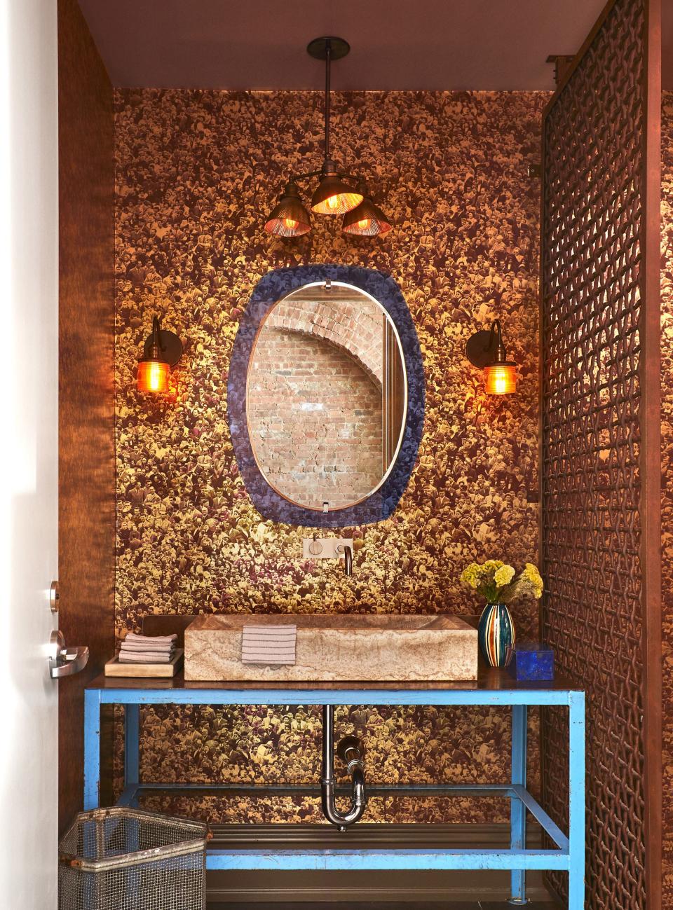 “It never fails that at every party people disappear into the powder room to take selfies,” says Liebman, a fact he attributes to Flavor Paper’s metallic Warhol-themed Mylar wall covering behind the vanity. It’s paired with a midcentury mirror by Veca and a table and iron wall divider found at an old cement factory.