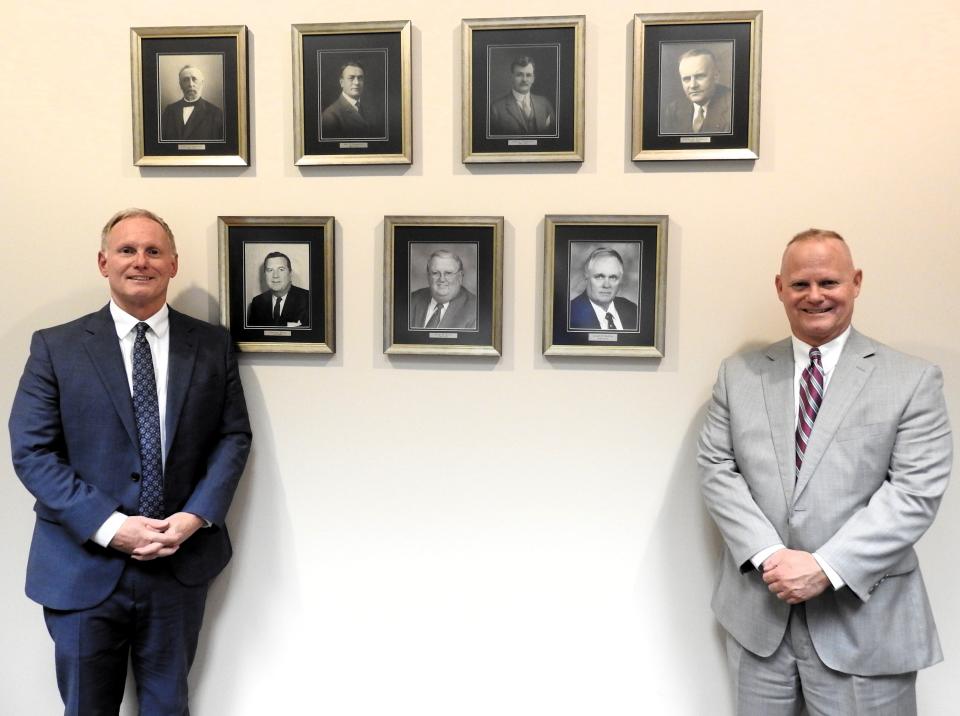 Bob and Jim Skelton with photos of past partners in the law firm now known as Pomerene, Burns & Skelton. The firm has undergone a lot of name changes over the years, but is the longest continual long firm in Ohio and oldest continual business in Coshocton, dating back to 1859.