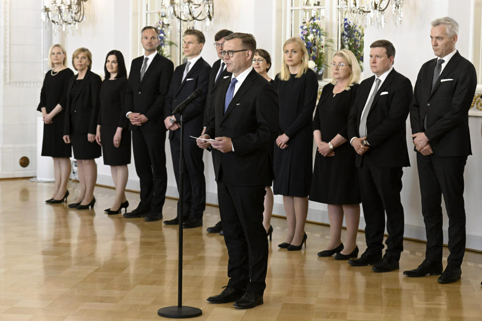 Finland's new Prime Minister Petteri Orpo, center, stands with some of his cabinet members, on the occasion of a complimentary visit to the President of Finland Sauli Niinisto at the Presidential Palace in Helsinki, Finland, Tuesday June 20, 2023. (Jussi Nukari/Lehtikuva via AP)