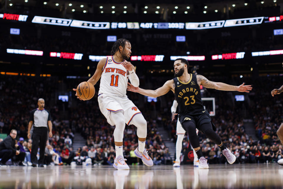 New York Knicks guard Jalen Brunson (11) is defended by Toronto Raptors guard Fred VanVleet (23) during the second half of an NBA basketball game Friday, Jan. 6, 2023, in Toronto. (Cole Burston/The Canadian Press via AP)