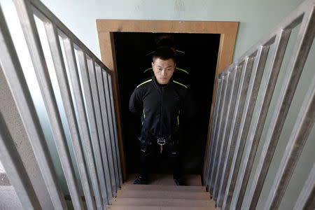 A trainee from Dewei Security waits to attend a daily training session at a training camp, on the outskirts of Beijing, China March 2, 2017. REUTERS/Jason Lee