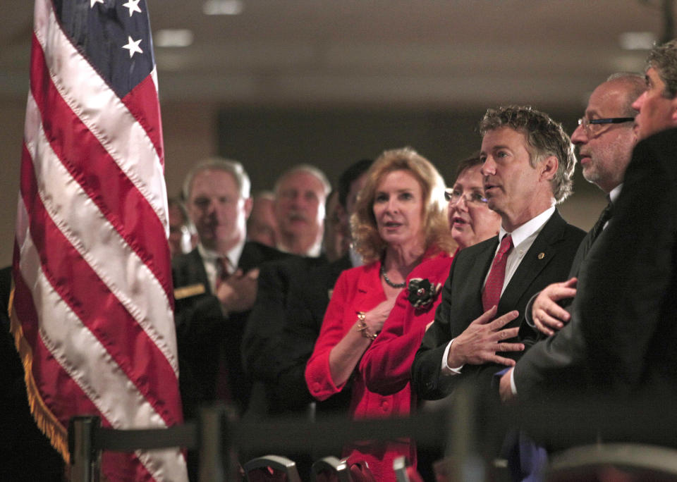 DETROIT, MI - DECEMBER 6: U.S. Sen. Rand Paul (R-KY) (red tie, third from right) says the Pledge of Allegiance before delivering a speech titled, 'Renewing the Opportunity for Prosperity: Economic Freedom Zones' at the Detroit Economic Club December 6, 2013 in Detroit, Michigan. As part of his plan to help save Detroit, the largest city in U.S. history to go bankrupt, and other economically depressed areas, the Senator will introduce legislation that will create so-called 'economic freedom zones' by lowering taxes in those areas and change the Visa rules to help make it easier for foreign entrepreneurs to immigrate to economically depressed cities. (Photo by Bill Pugliano/Getty Images)