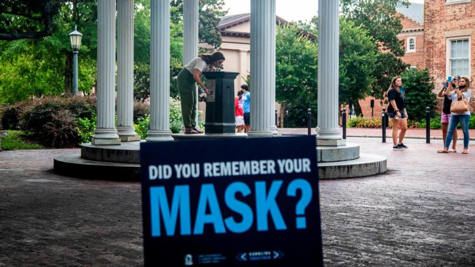 A sign at the Old Well at UNC-Chapel Hill encourages wearing a mask amid the coronavirus pandemic in the first week of August. .