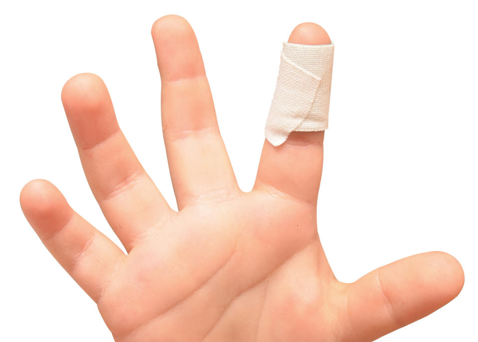 Child's hand with a bandage on the index finger, suggesting injury and care