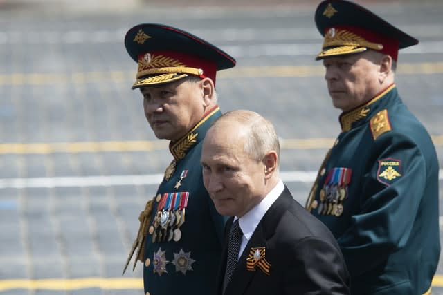 Russian President Vladimir Putin, centre, and, defense minister Sergei Shoigu, left, leave Red Square after the Victory Day military parade (Pavel Golovkin/AP)