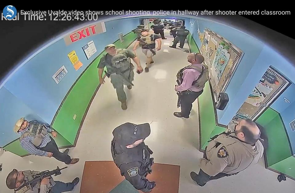 Surveillance video show authorities stage in a hallway as they respond to the shooting at Robb Elementary School in Uvalde, Texas, on May 24, 2022.