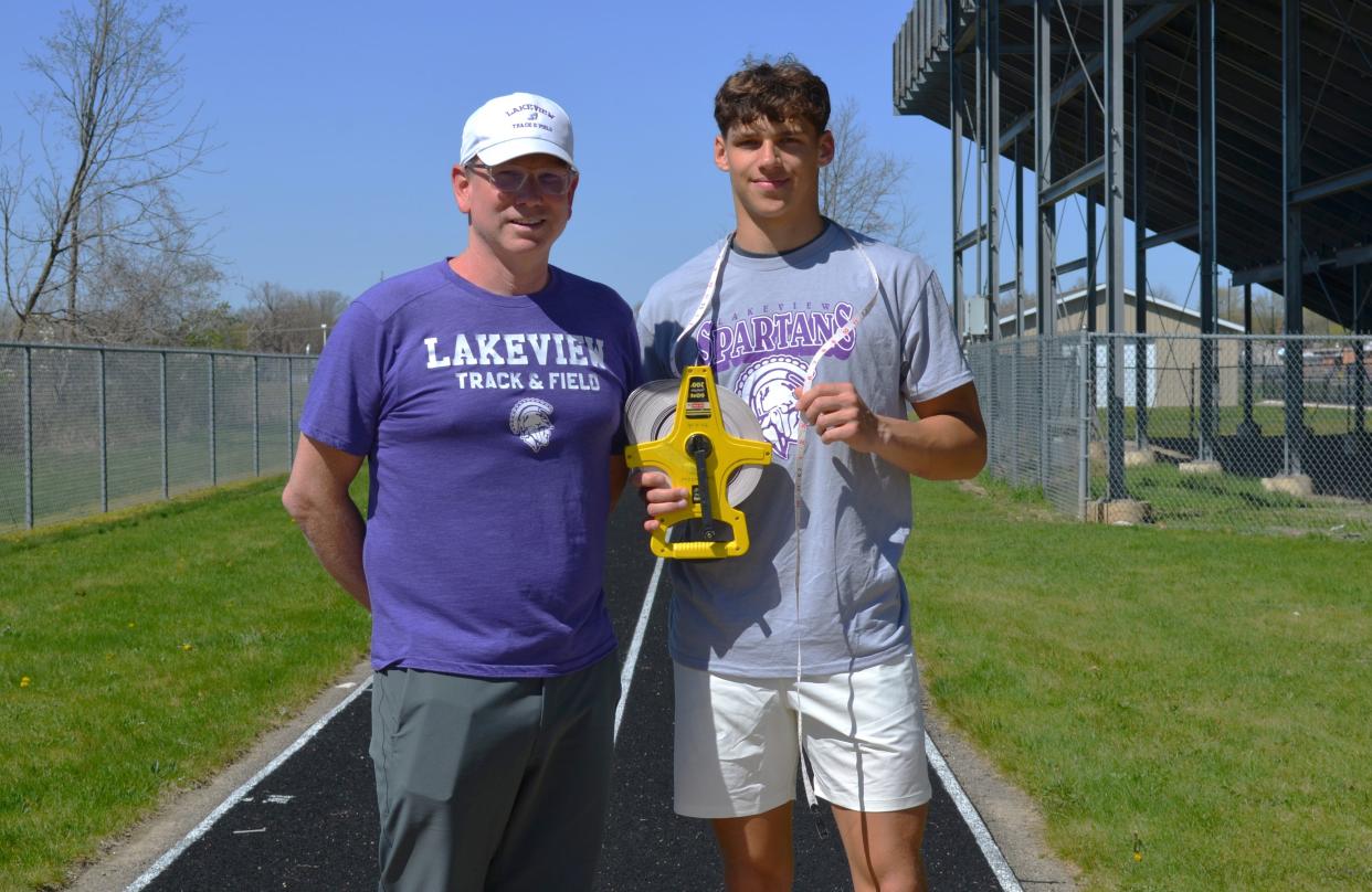 Lakeview senior track standout Davis Barr, right, recently set the school record for the long jump, which was held previously by Spartan assistant coach Jason Moore back in 1992.