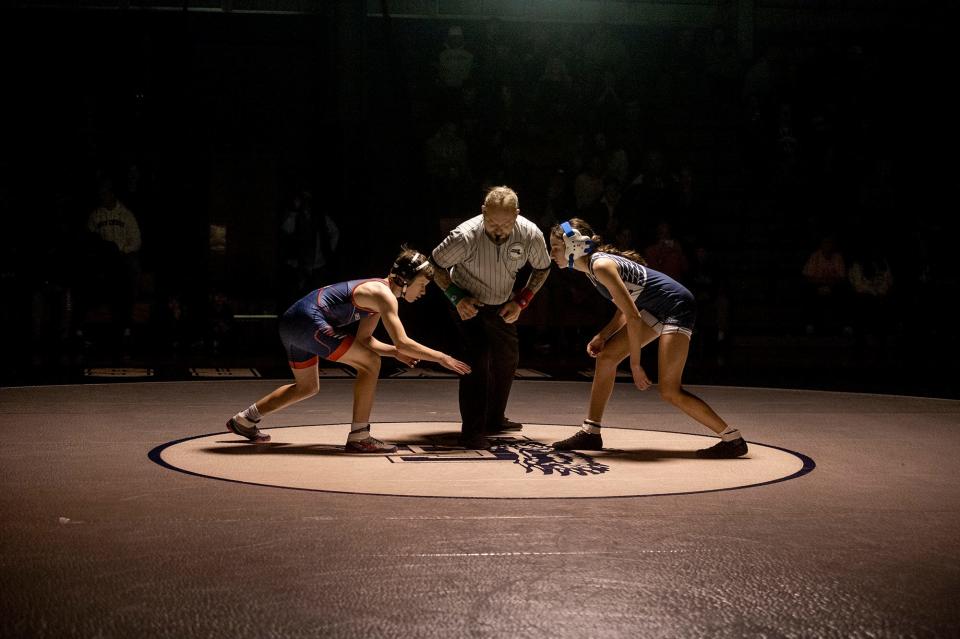 Natick High School's Mike Mortarelli, left, and Framingham's Penelope Trostel started things off in the 106 lb. weight class, Feb. 7, 2024.