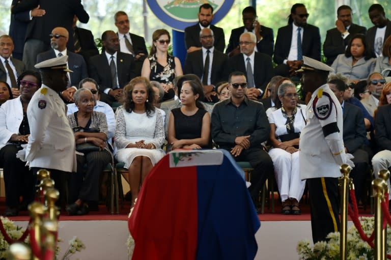 The family of former Haitian president Rene Preval attends a ceremony for Preval at the Haitian National Pantheon Museum, in Port-au-Prince, on March 10, 2017