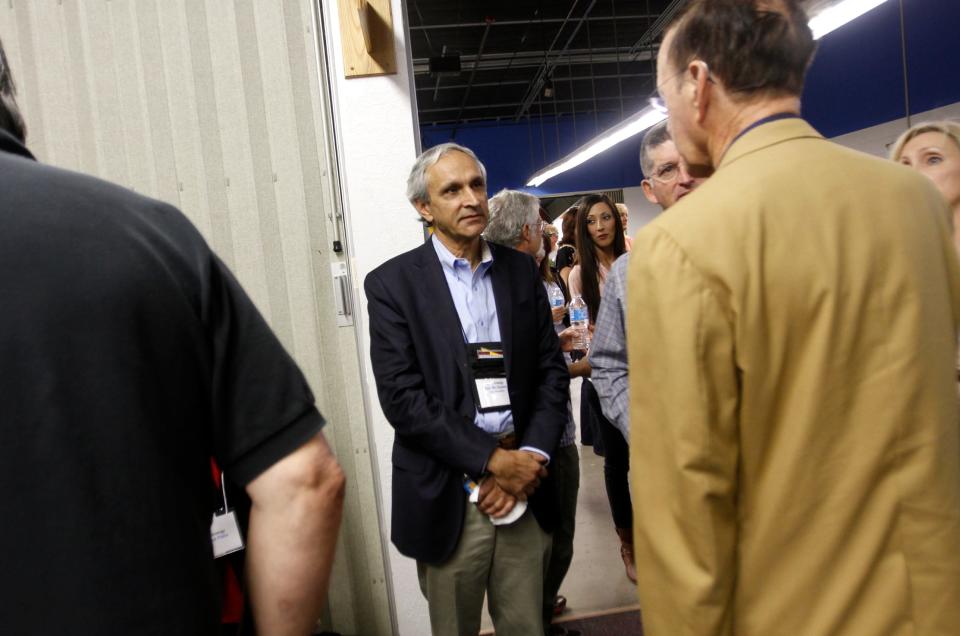 At center, WPX Energy Vice-President Ken McQueen talks with New Mexico Tech Associate Director, New Mexico Center for Center for Energy Policy Daniel Fine, right on May 12, 2016 during the Four Corners Oil and Gas Conference at the McGee Park Convention Center in Farmington.