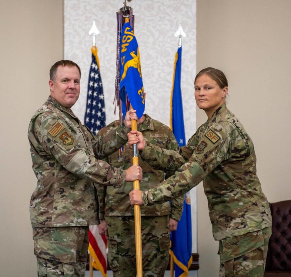 From right, U.S. Air Force Lt. Col. Jennifer Titkemeier, 375th Security Forces Squadron commander, assumes command during a change of command ceremony on Scott Air Force Base. Titkemeier previously served as the Chief of Current Operations and Force Protection divisions at Special Operations Command Central, MacDill Air Force Base, Florida.