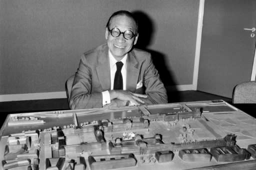 Architect I.M. Pei poses with a model of the Louvre Pyramid in Paris in 1985