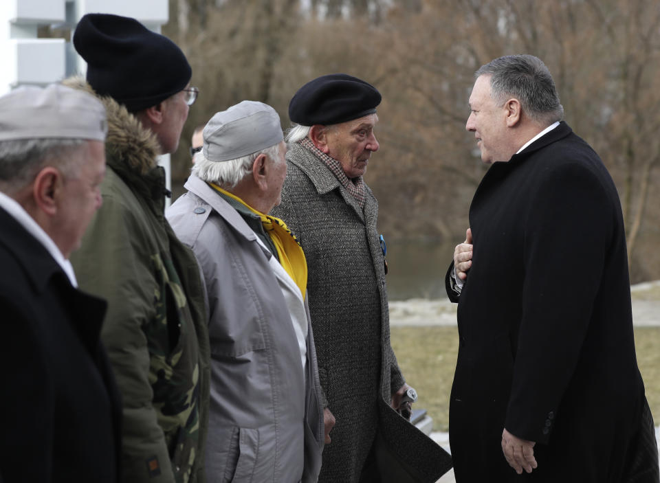 US Secretary of State Mike Pompeo , right, meets with members of Slovakia's confederation of political prisoners at the Freedom Gate memorial in Bratislava, Slovakia, Tuesday, Feb. 12, 2019. Pompeo on Tuesday invoked the 30th anniversary of the demise of communism to implore countries in Central Europe to resist Chinese and Russian influence. (AP Photo/Petr David Josek)