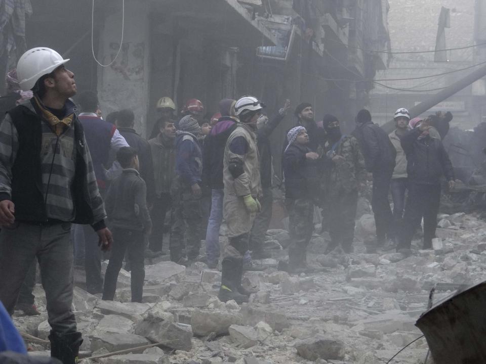 Residents look for survivors at a damaged site after what activists said was an air strike from forces loyal to Syria's President Bashar al-Assad in the Karam Al-Beik area of Aleppo