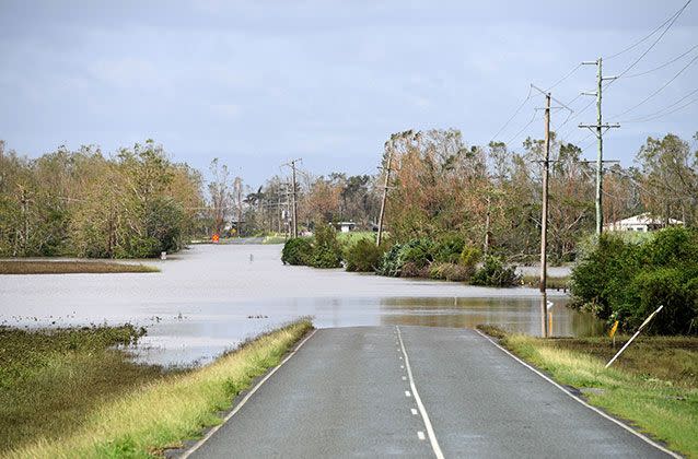 Flood waters cover a road near Proserpine. Picture: AAP/Dan Peled