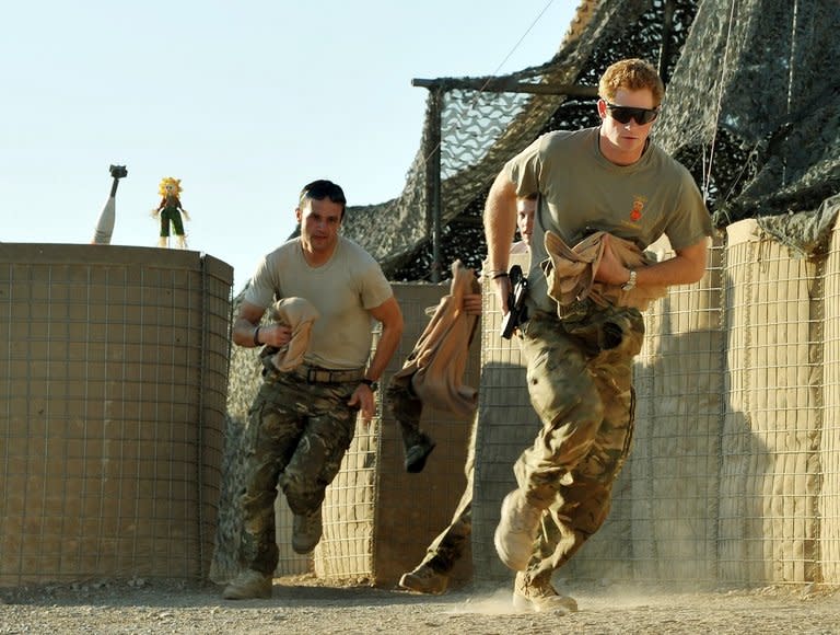 Picture taken on November 3, 2012 shows Britain's Prince Harry (R) running out of the VHR (very high ready-ness) tent to scramble his Apache with fellow pilots at Camp Bastion in Afghanistan's Helmand Province. Harry said he killed Taliban fighters during his stint as a helicopter gunner in Afghanistan, in comments that can be reported after he completed his tour of duty Monday