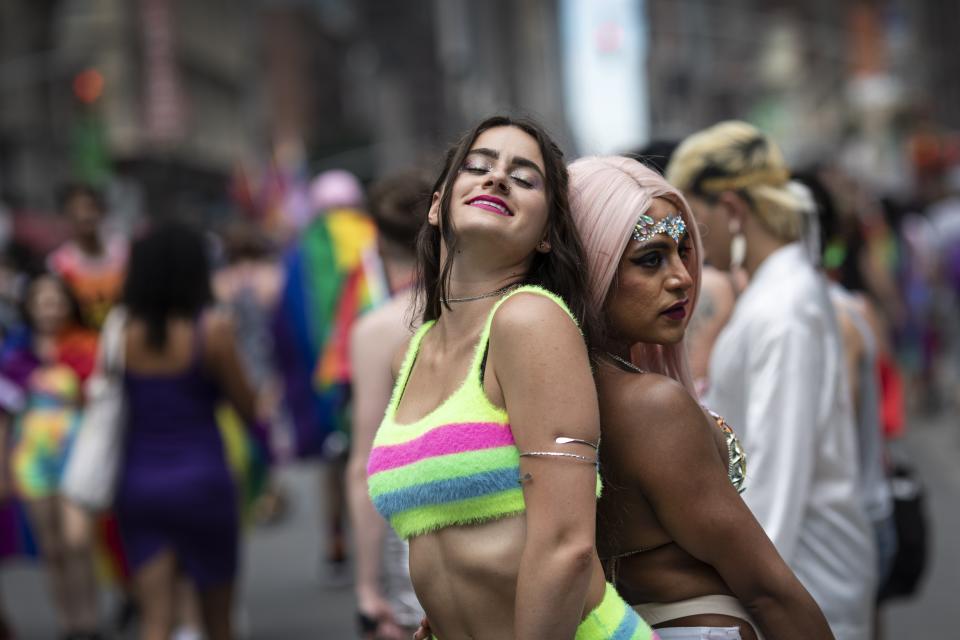 Parade-goers pose for photographs on the streets during the LBGTQ Pride march on Sunday, June 30, 2019, in New York, to celebrate five decades of LGBTQ pride, marking the 50th anniversary of the police raid that sparked the modern-day gay rights movement. (AP Photo/Wong Maye-E)