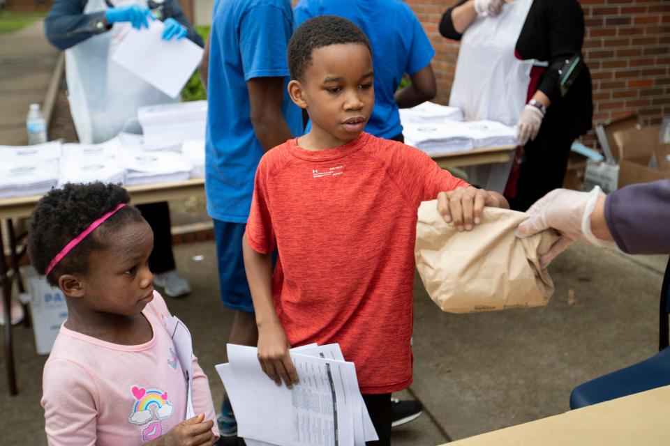 Camaree Hurd, 9, and his 6-year-old sister, Amani, get lunches from the Memphis YMCA on March 23.