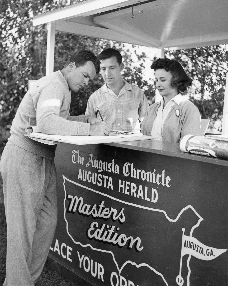 FILE - Jack Burke Jr., winner of the 1956 Masters, signs autographs.