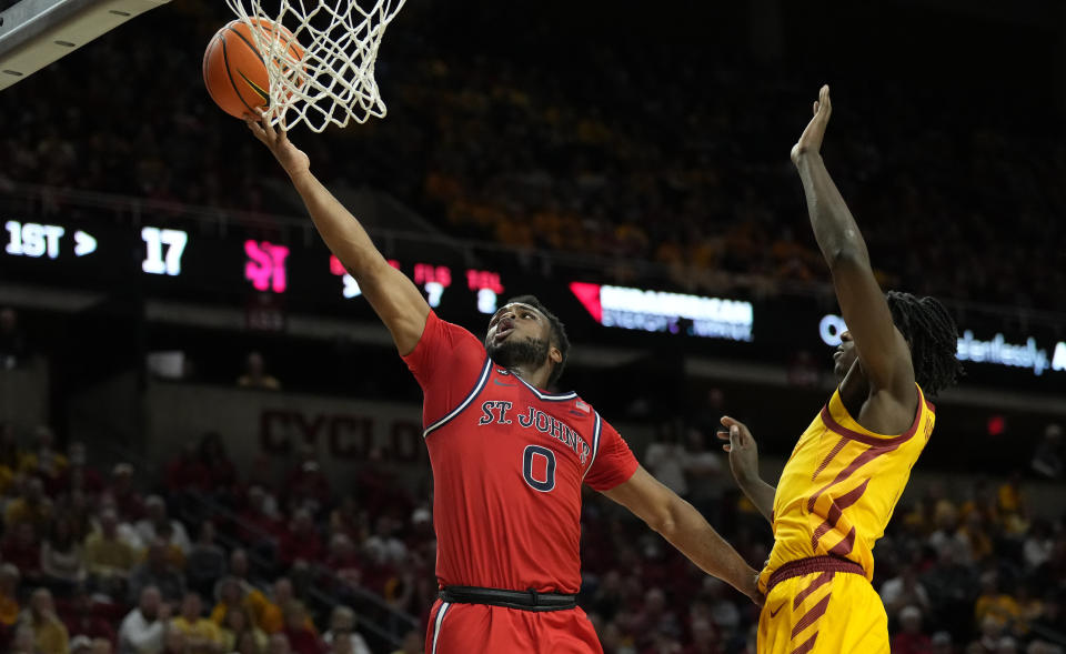 St. John's guard Posh Alexander (0) breaks free for a basket past Iowa State guard Demarion Watson, right, during the first half of an NCAA college basketball game, Sunday, Dec. 4, 2022, in Ames, Iowa. (AP Photo/ Matthew Putney)